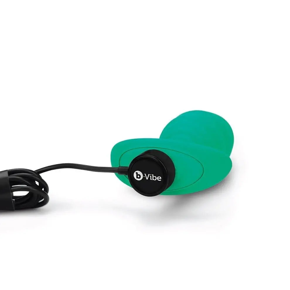 Green vibe earphones displayed with b-Vibe Large Texture Plug for enhanced experience