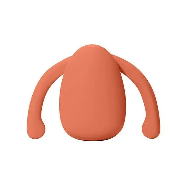 Coral-colored, egg-shaped Dame Eva hands free stimulator with curved arm-like protrusions