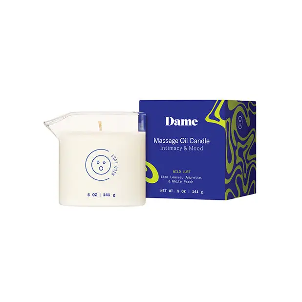 Massage oil candle in white container with blue and green box by Dame; plant-based massage oil