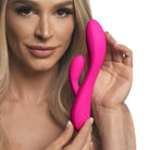 Woman holding pink brush next to the 10x Flexible Silicone Rabbit Vibrator using water based lubricants