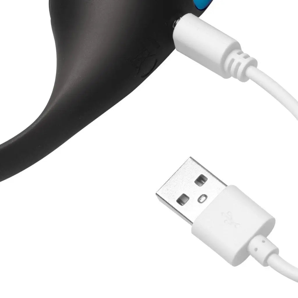 Partial view of vibrating prostate plug with 10x inflatable feature and white charging cable