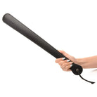 Woman holding 19 inch slapper paddle made of black leather