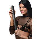 A woman in a black fishnet top holding a 19 inch slapper paddle