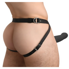 Man wearing a black leather belt with a silver buckle holding a silicone penis sheath