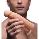 Prosthetic finger held by a hand showcasing 2 inch silicone penis extension