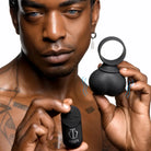 A man demonstrating 28x vibrating balls, a powerful black and white pleasure device