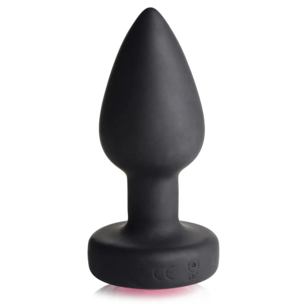 Black silicone anal plug with pink gem, tapered tip, and flared base for enhanced pleasure