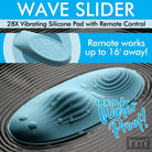 Teal-colored vibrating silicone pad with rippled surface and water droplets