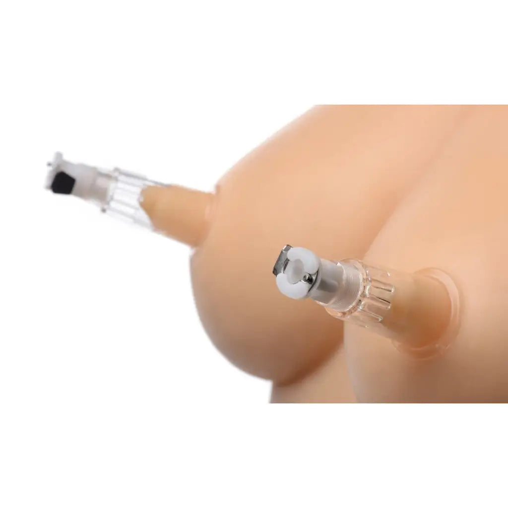 Insulin injection pen needle held between fingers with clit pump in the background