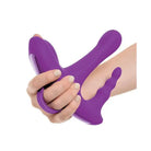 Hand holding 3Some Rock N’ Ride, a purple vibrating device for ultimate pleasure