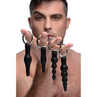 Set of four black anal plugs with ring handles, various inches insertable length