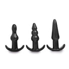 Three black silicone anal plugs with different shapes in a 4 Piece Vibrating Anal Plug Set