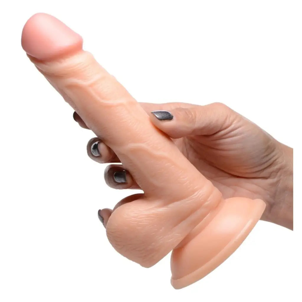 Finger with a ring next to the 7.5 Inch Realistic Dildo With Balls for size comparison