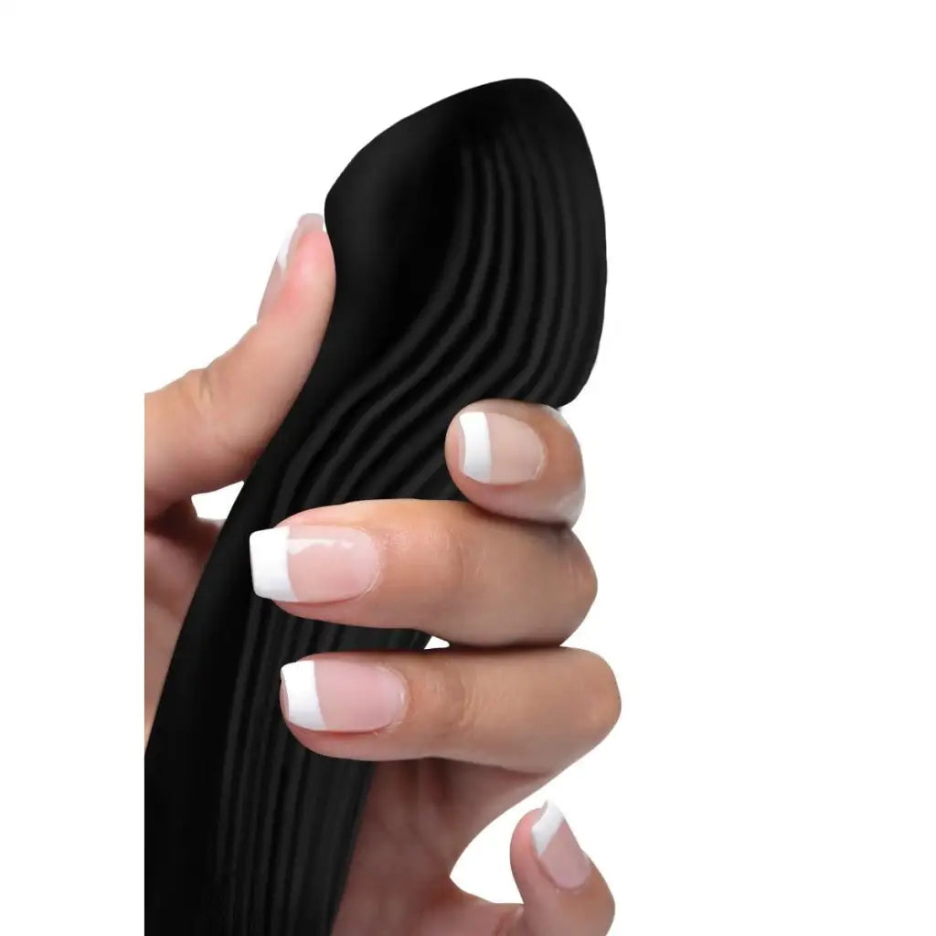 Black silicone vibrator with ridges held by manicured fingers - Bendable Silicone Vibrator