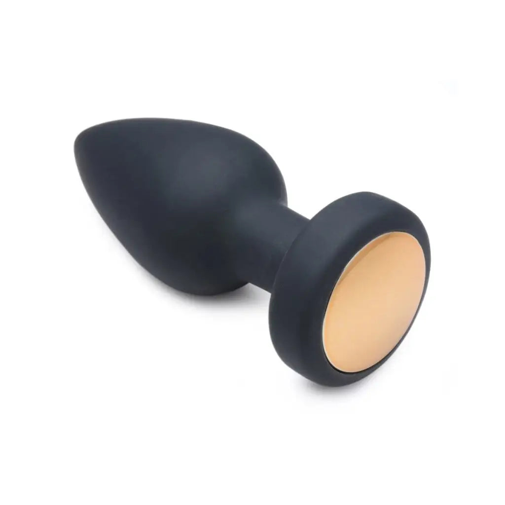 Black silicone rechargeable anal plug with a beige-colored base by Booty Sparks