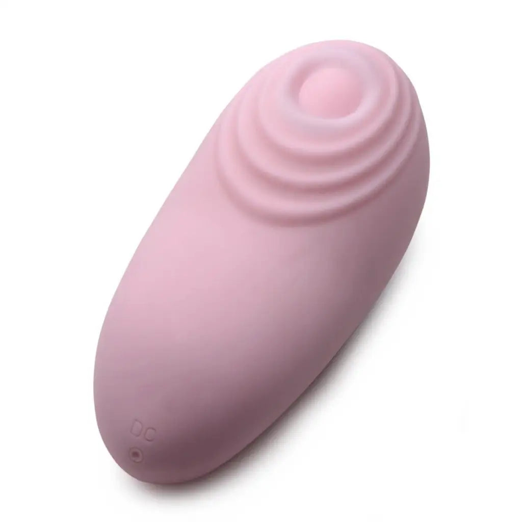 Pink, oval-shaped pulsing silicone clit stimulator with concentric circles on one end