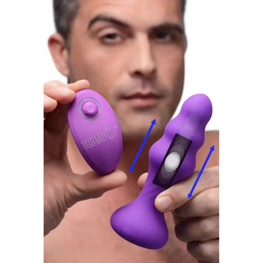 Hand-held 7x Slim Ribbed Thumping Silicone Anal Plug with purple vibrating components