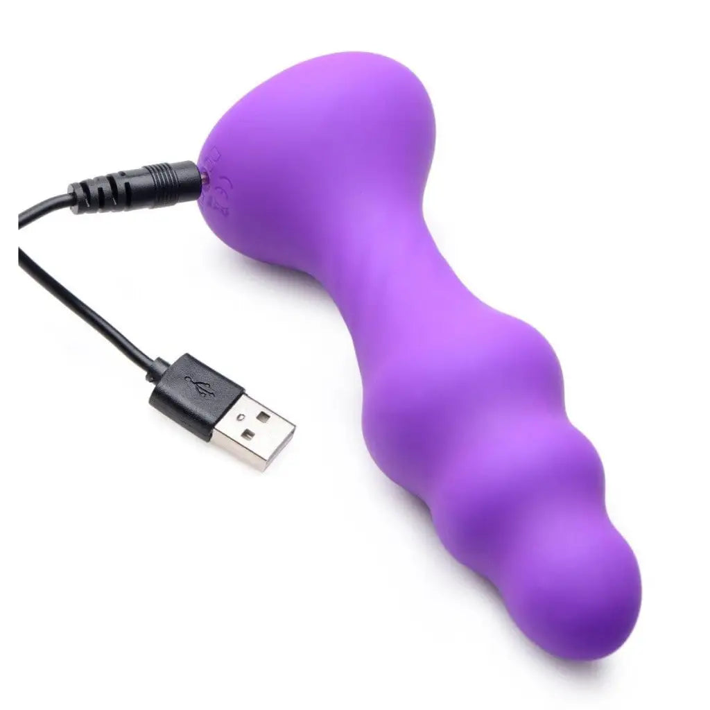 Purple silicone anal plug with USB cable, featuring a slim ribbed thumping design