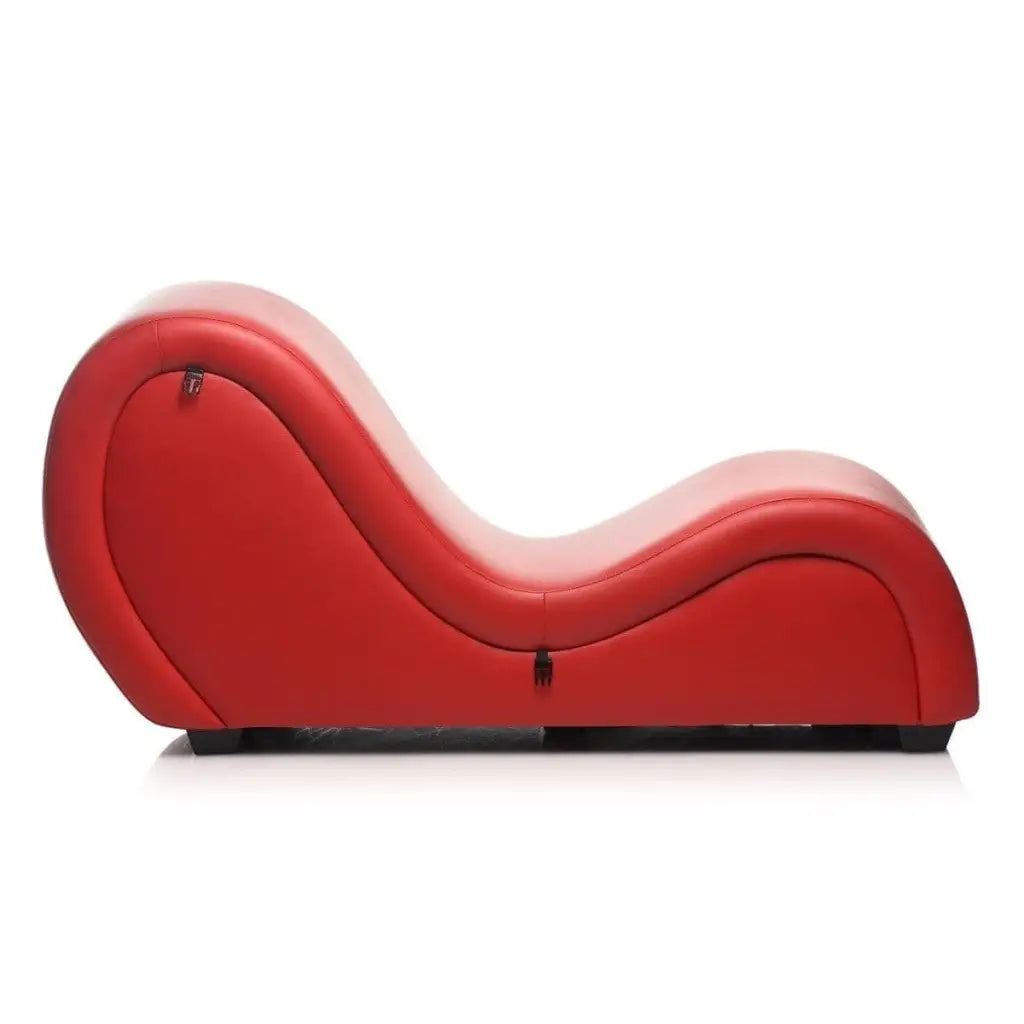 Curved red leather chaise lounge with sensual S-shape, paired with adjustable pussy clamp