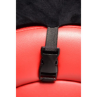 Black plastic buckle on red leather surface of an adjustable pussy clamp with a chain leash