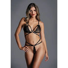 Woman in Adore ’The Flame’ strappy lace bra and thong in black