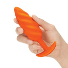 Hand holding an orange toy from b-Vibe Medium Texture Plug