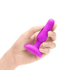 A hand holding b-Vibe Novice Plug - Vibrating Plug for the best anal play experience