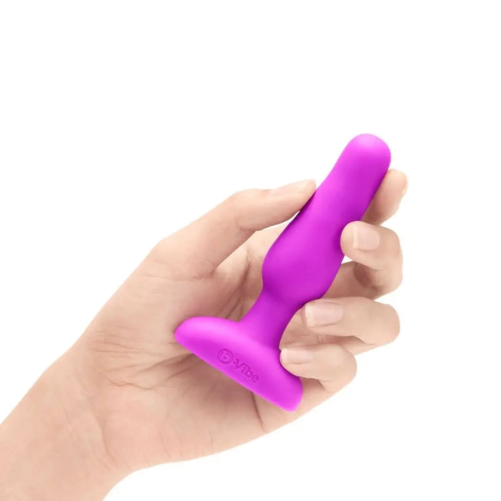 A hand holding b-Vibe Novice Plug - Vibrating Plug for the best anal play experience