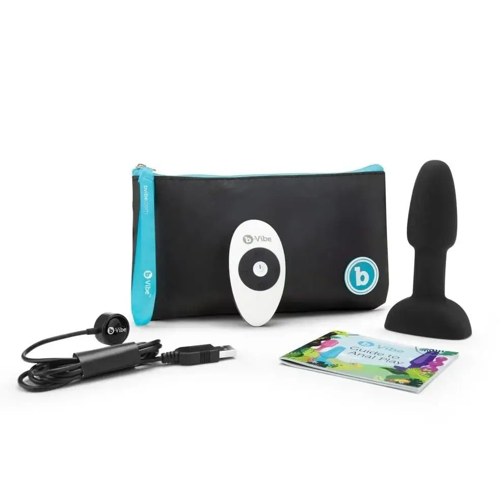 Bluetooth portable speaker and b-Vibe Petite Rimming Plug set against a sleek black case