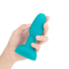 Hand holding b-Vibe Petite Rimming Plug, showcasing blue foame design