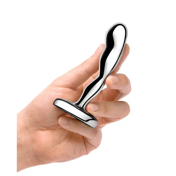 Hand holding b-Vibe stainless steel prostate plug for enhanced pleasure