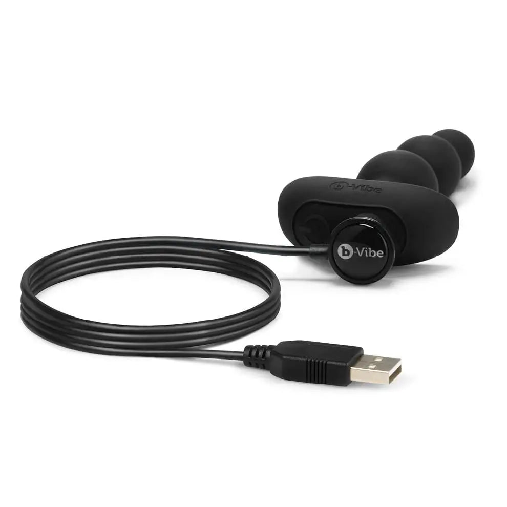 Earphones connected to USB cable on b-Vibe Triplet Anal Beads packaging