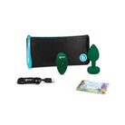 b-Vibe Vibrating Jewel Plug green toy next to bag, elegant and pleasurable accessory