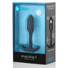 Close up of b-Vibe Weighted Snug Plug 1 with a smooth grip handle in a black box