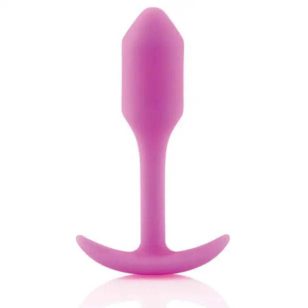 Pink silicone b-Vibe Weighted Snug Plug 1 with smooth grip handle and long tail, 55 grams