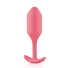 b-Vibe Weighted Snug Plug 2 - 114 Grams with a pink plastic spoon handle