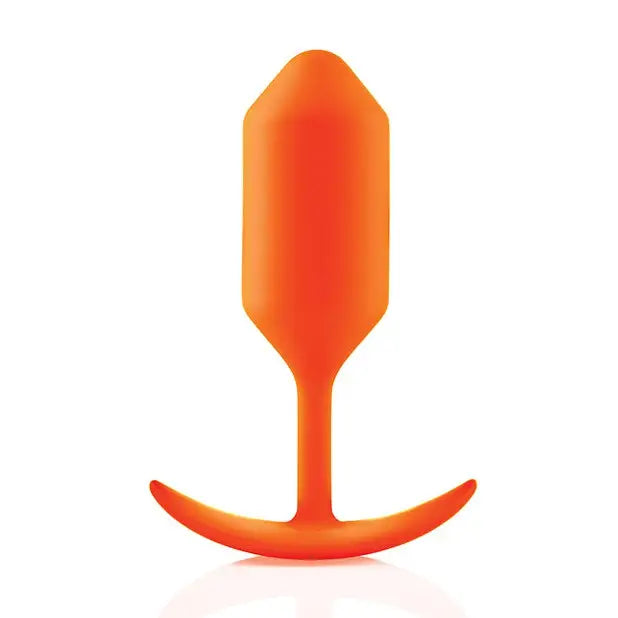 Orange plastic spoon handle with b-Vibe Weighted Snug Plug 3 - 180 Grams