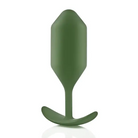 Close up of green b-Vibe Weighted Snug Plug 4 with smooth grip handle and flexible neck