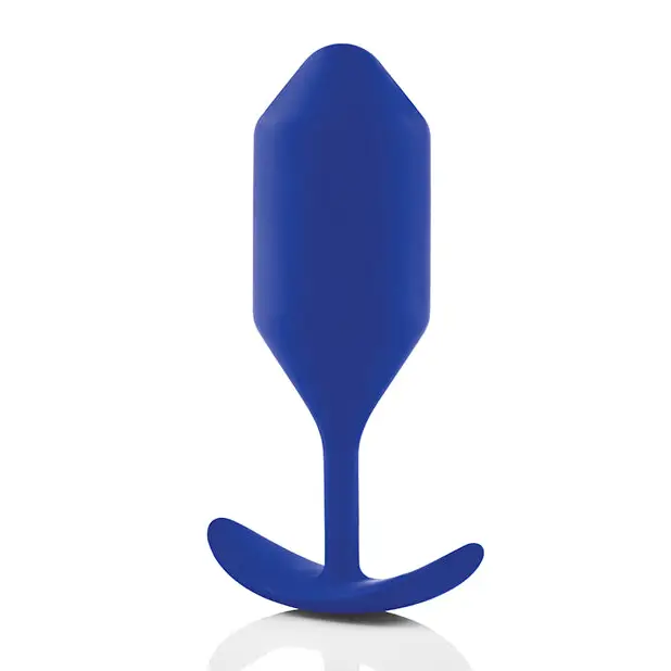 A blue plastic spoon with a curved, smooth grip handle for b-Vibe Weighted Snug Plug 4