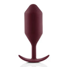 b-Vibe Snug Plug: Red plastic, wine bottle-shaped weighted butt plug with a curved top