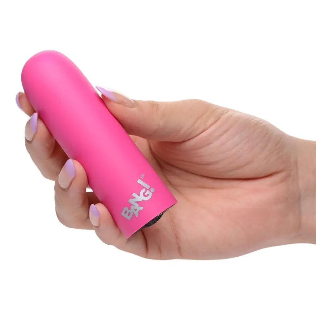 Hand holding a pink BANG! 10x Mega Silicone Bullet Vibrator for high-powered pleasure