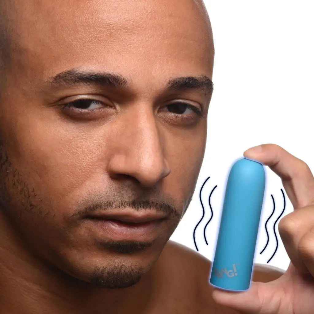 Blue 10x Mega Silicone Bullet Vibrator near face, indicating vibration or sound waves