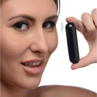 BANG! 10x rechargeable vibrating metallic bullet held between fingers, sleek black design