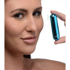 Woman holding BANG! 10x rechargeable vibrating metallic bullet near her face