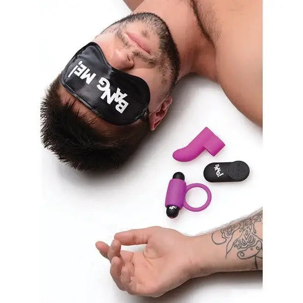 Sleeping person wearing ’BANG ME’ eye mask next to love ring and finger vibe from BANG! 28X Couple’s Kit