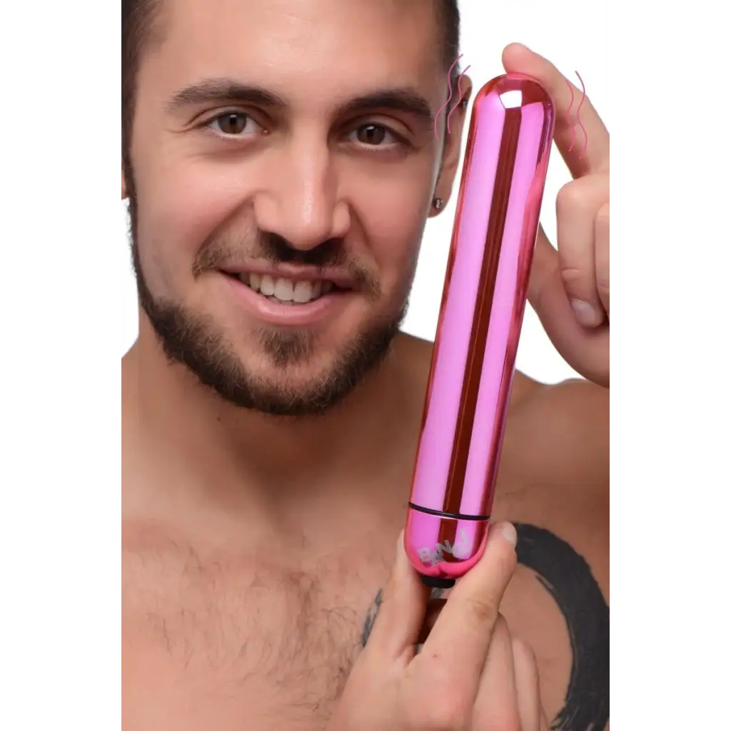 Smiling person holding a pink BANG! 3-Speed XL vibrating metallic bullet