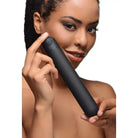 Close-up of person holding BANG! XL Bullet Vibrator made from ABS plastic near their face