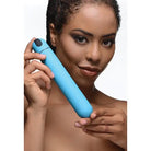 Woman holding BANG! XL Bullet Vibrator, a blue cylindrical massager made of ABS plastic