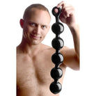 Man holding Black Baller Anal Beads in hands, showcasing black baller anal product