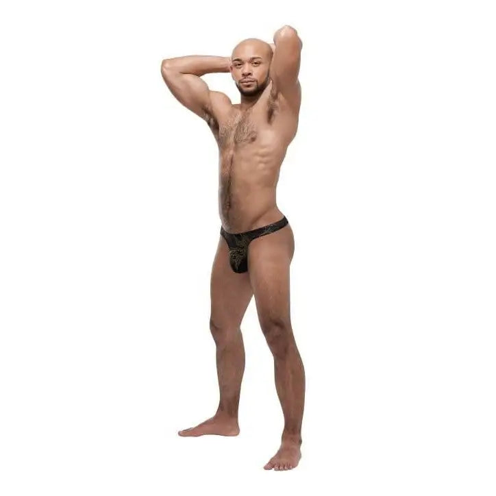 Shirtless muscular man in Black Gold Thong striking a powerful pose